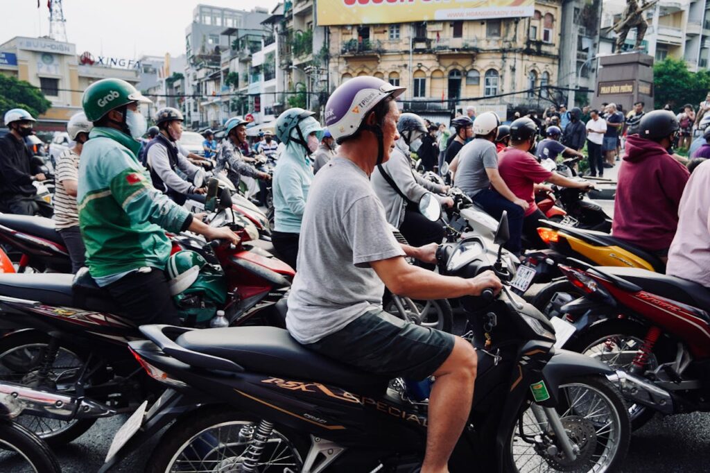 It is fine to put your hand on the driver's shoulder when getting on or off the Grab bike